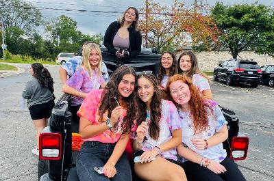  Students in the leadership course pose for picture sitting in bed of a pick-up truck in parade